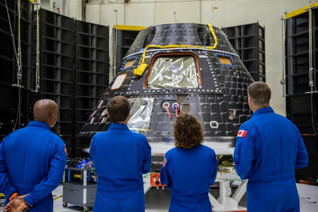 Artemis II crew members, shown inside the Neil Armstrong Operations and Checkout Building at NASA’s Kennedy Space Center in Florida, check out their Orion crew module on Aug. 8, 2023. From left are: Victor Glover, pilot; Reid Wiseman, commander; Christina Hammock Koch, mission specialist; and Jeremy Hansen, mission specialist. The crew module is undergoing acoustic testing ahead of integration with the European Service Module. Artemis II is the first crewed mission on NASA’s path to establishing a long-term lunar presence for science and exploration under Artemis.